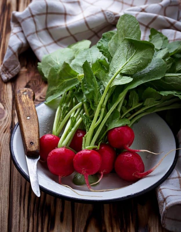 Fresh radishes and knife
